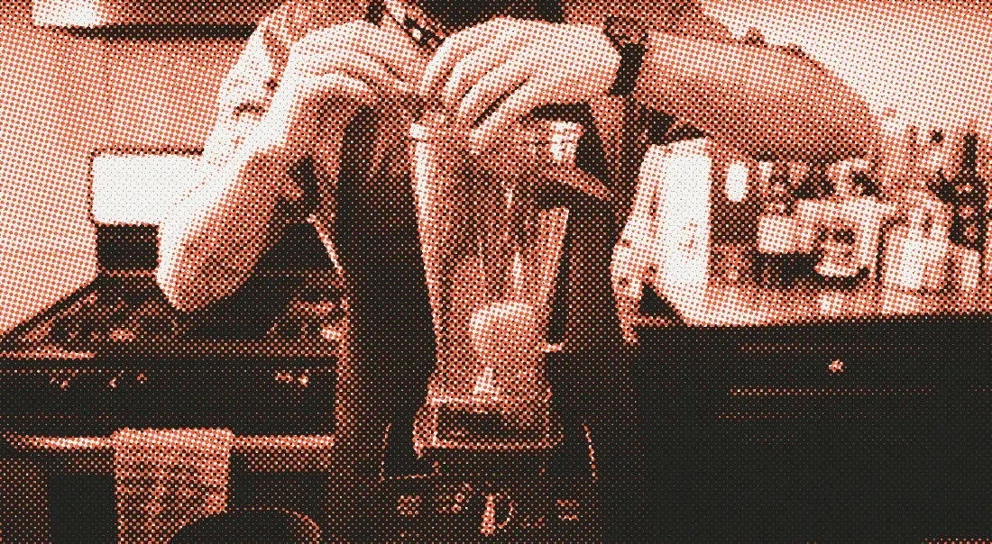Andrew Rea at a blender in his kitchen, a black Time Teller on his wrist