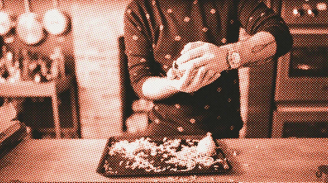 Andrew Rea grating cheese over a baking sheet, a steel Rolex GMT on his wrist