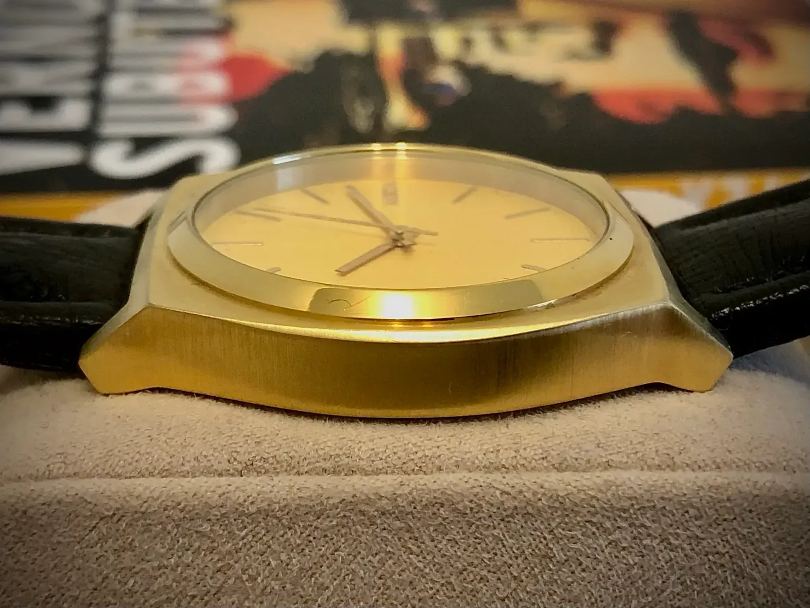 The Time Teller seen from the side at dial level, showing its slim brushed case and raised polished bezel